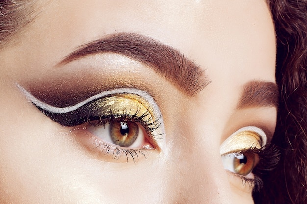 A close-up of a brides eye with gold and pink shimmer.
