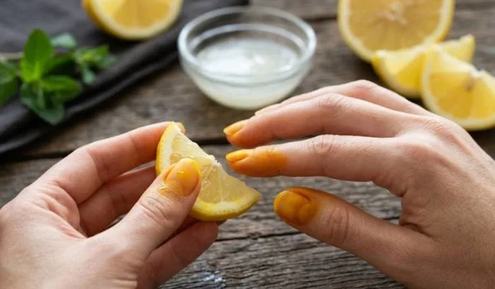 Yellow turmeric (haldi) stains on fingernails from cooking Indian food and kitchen preparation.