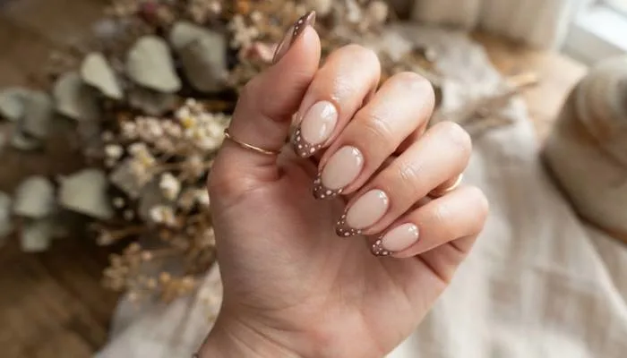 Trendy Bambi French tip nail design with soft brown tips and tiny white fawn spots